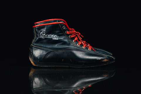 Authentic racing shoes worn by Jacky Ickx during his legendary 1970s motorsport career. / Scarpe da corsa autentiche indossate da Jacky Ickx durante la sua leggendaria carriera negli anni '70.