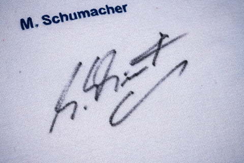 Close-up of Michael Schumacher’s autograph on Ferrari shirt. / Dettaglio della firma di Michael Schumacher sulla maglia Ferrari