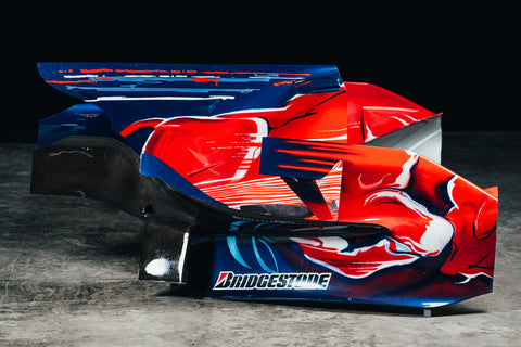 Close-up of the Toro Rosso STR3 engine cover, featuring Red Bull and STR branding. / Dettaglio del cofano motore Toro Rosso STR3 con i loghi Red Bull e STR.