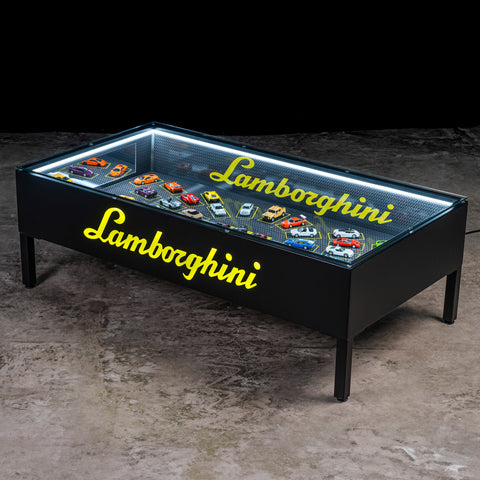 Lamborghini scale model table with glass top. / Tavolo con modellini Lamborghini e piano in vetro