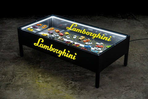 Lamborghini scale models arranged under glass. / Modellini Lamborghini disposti sotto vetro