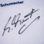 Close-up of Michael Schumacher’s autograph on Ferrari shirt. / Dettaglio della firma di Michael Schumacher sulla maglia Ferrari